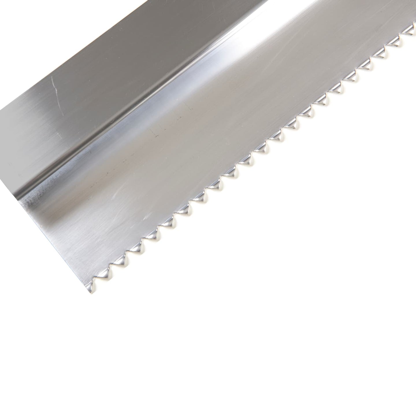 close up view of the end of a serrated edged metal tool