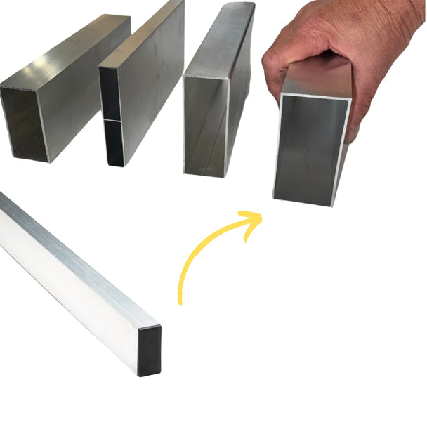 a hand holding metal straight edge tools