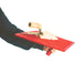 Red trowel with a wooden handle being held by a person on a white background