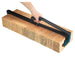 Stack of bricks being held using a black metal tool, held by a hand
