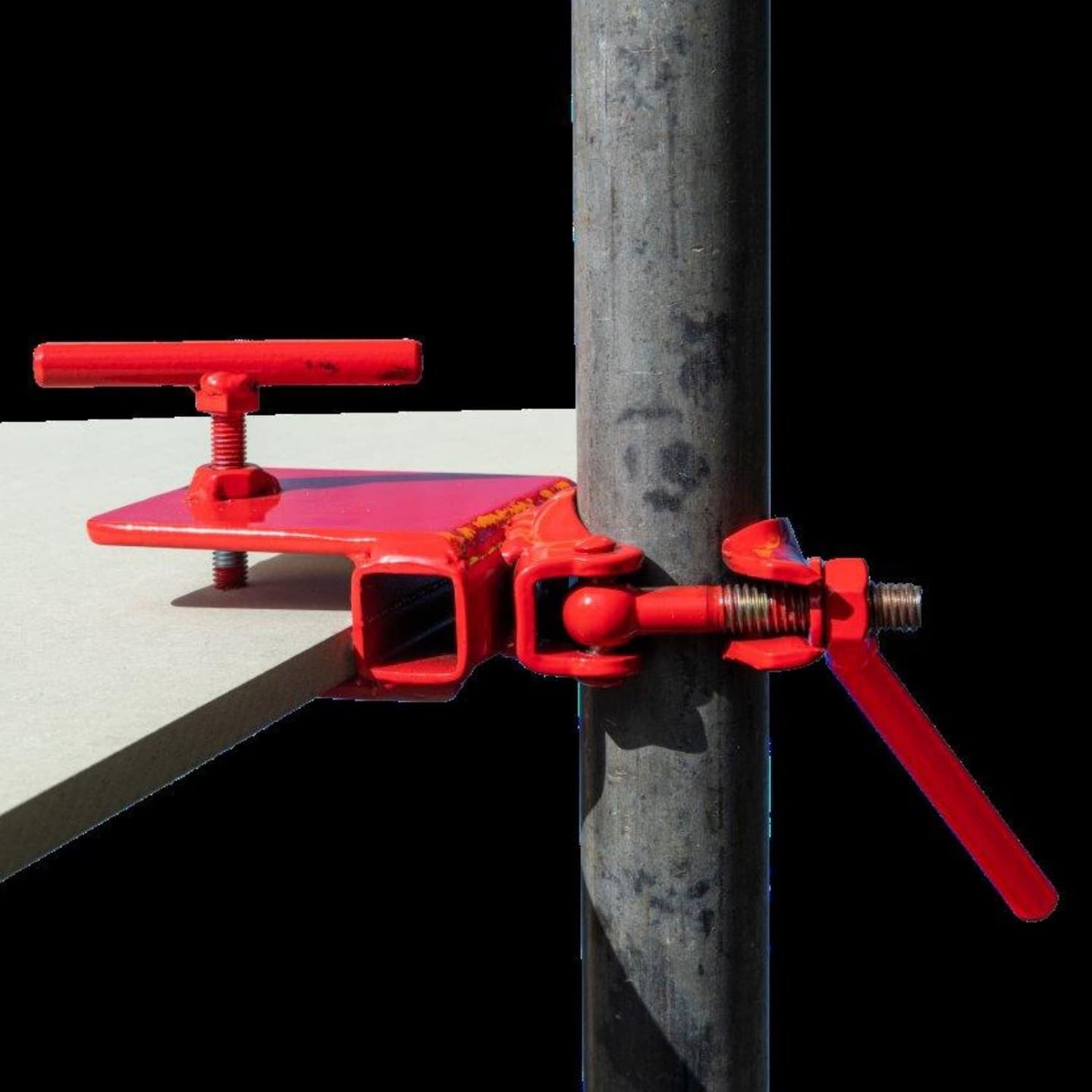 Red clamp tool attached to a metal pole on a black background