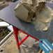 Site image of red mortar stand and board with mortar on top