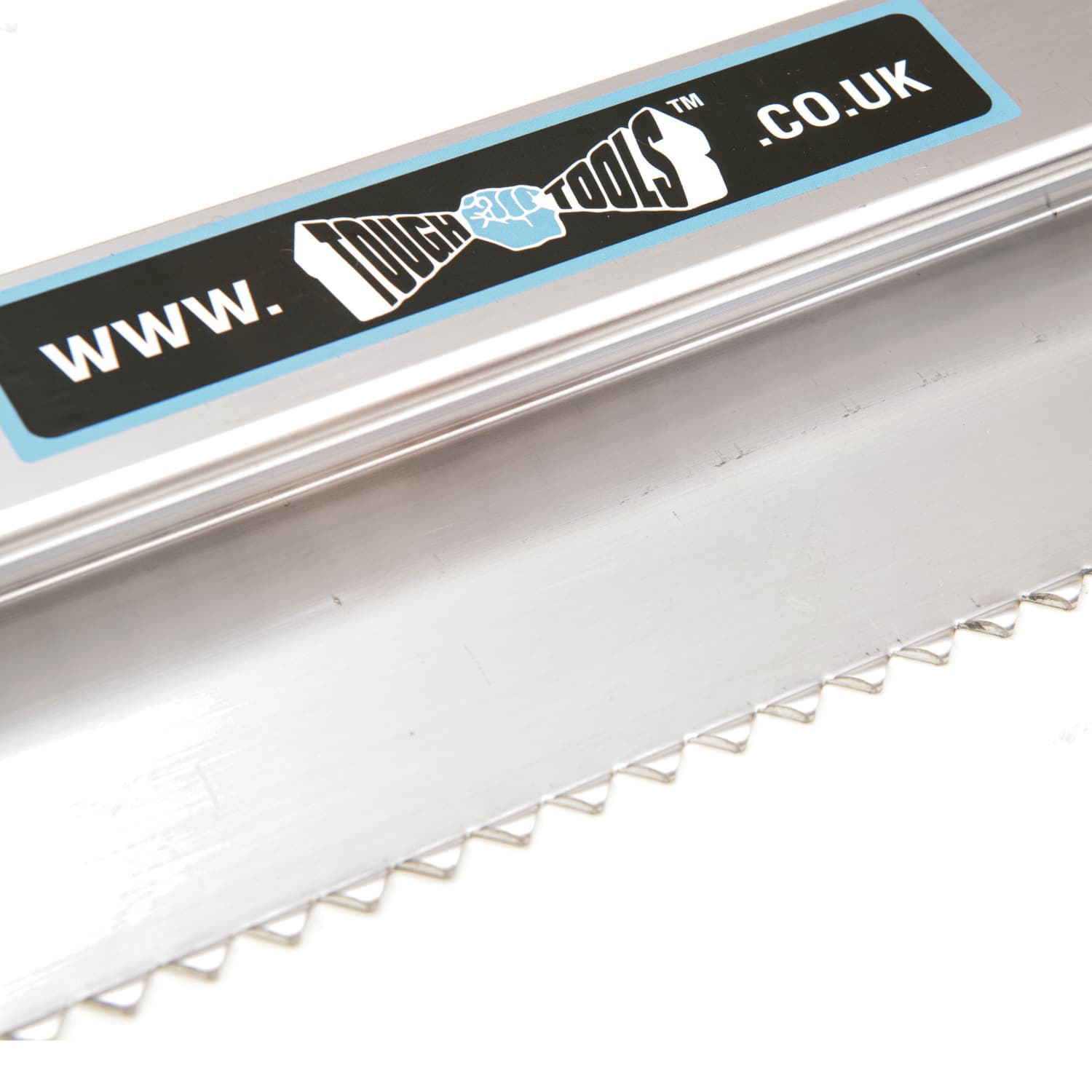 close up of metal plastering tool with serrated teeth