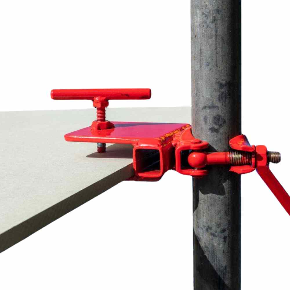 Red metal clamp fixed to a scaffold pole holding a mortar table