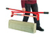 man stood holding a kerbstone lifting tool next to a grey kerbstone